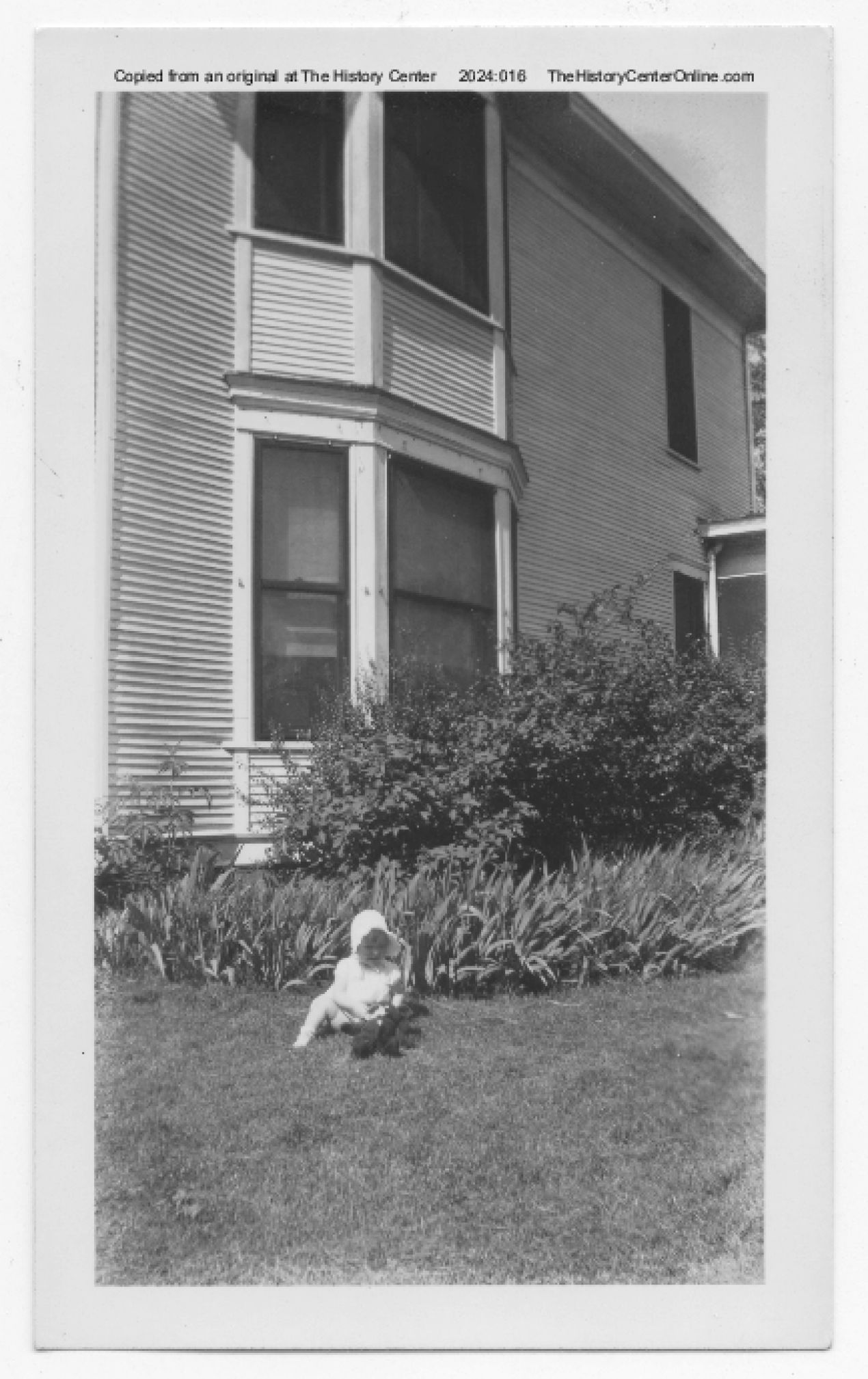 1945, Baby next to house