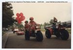 1986, 1988, Clowns on three wheelers riding next to railroad tracks during Diboll Day Parade, by Kodak, Diboll, Texas, ca.