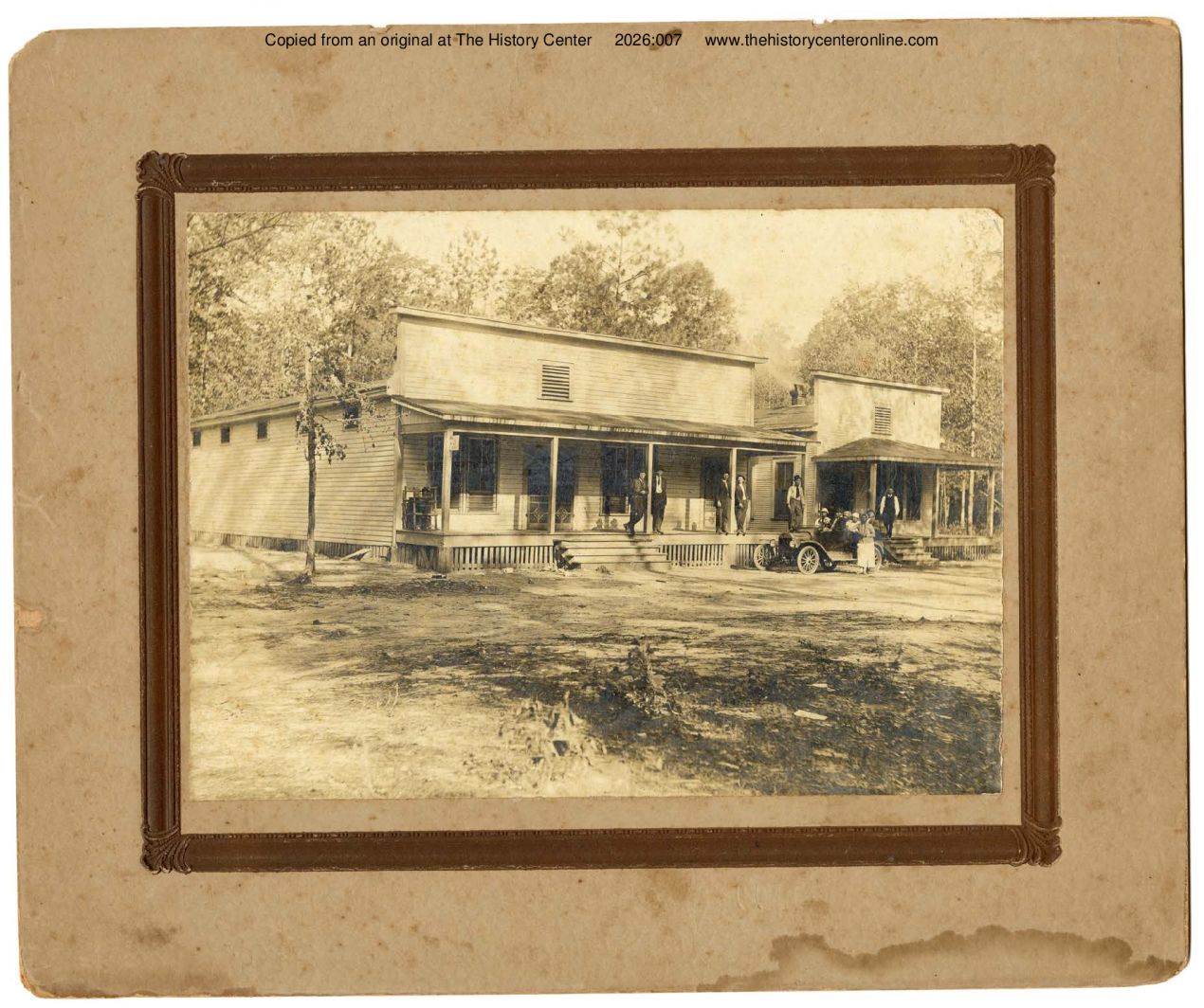 1915, Two buildings in unknown location with family standing around automobile, connected with Scott Family, ca.