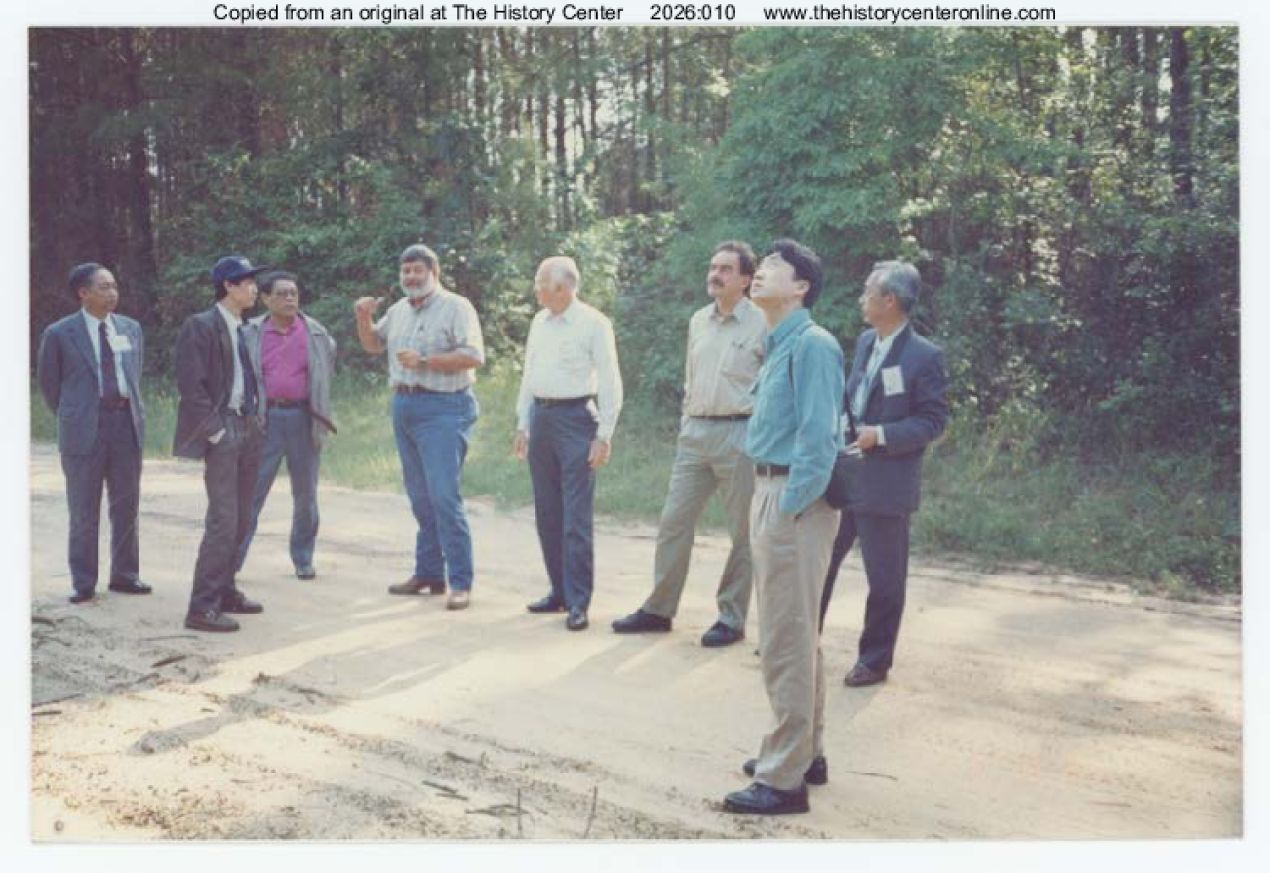 1994, Zhao Binyi (Director of The General Station of Forest Pest Control #58 in Shenyang, China) standing in street while visiting Jasper, Texas